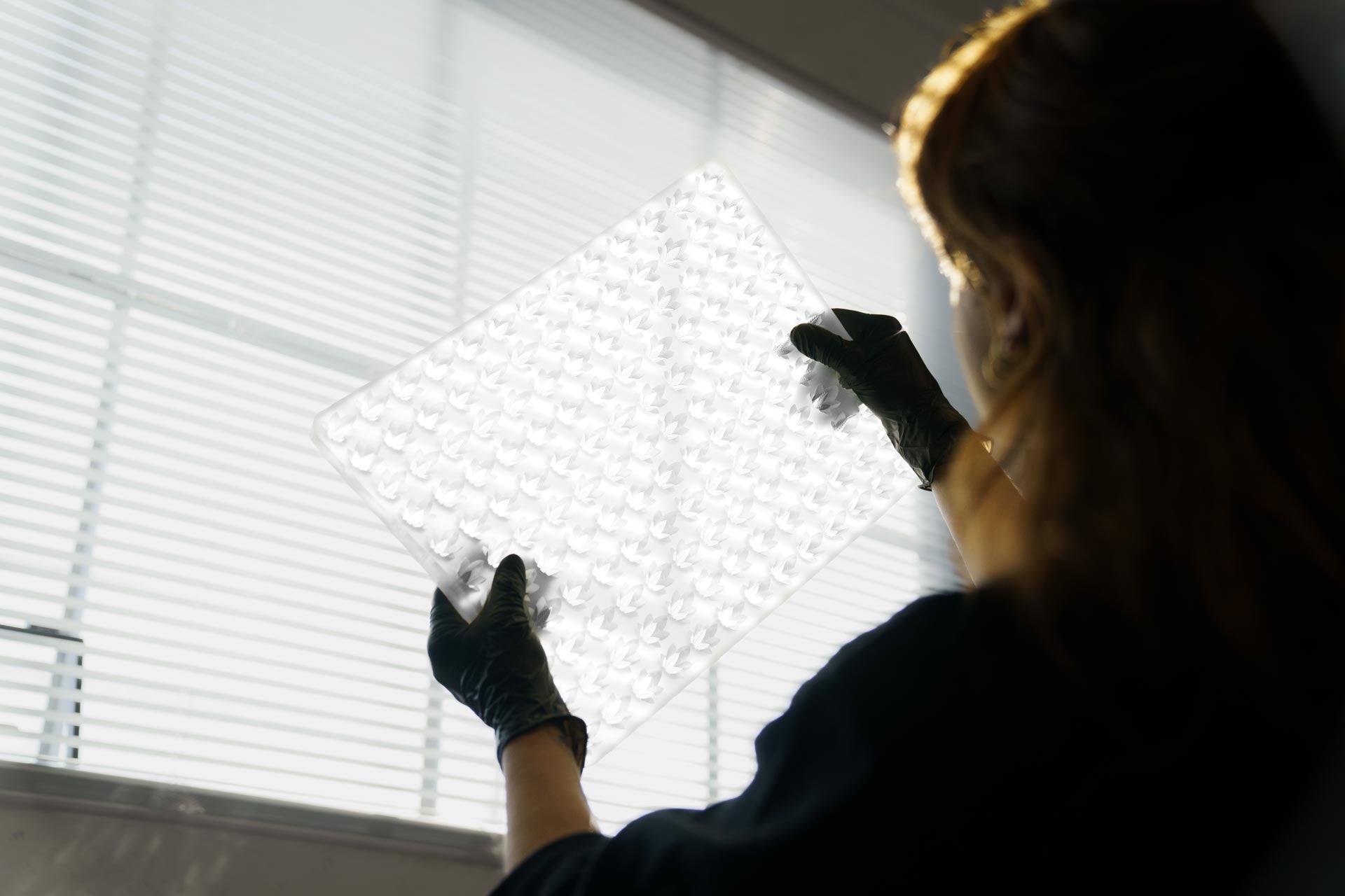 a half sheet sized silicone mold under inspection by bold maker staff