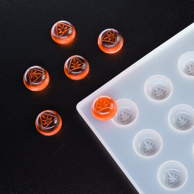 Transparent silicone mold with cannabis leaf design on a black background