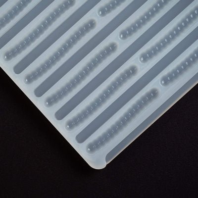 cornercloseup5mLGummyWormDepositorCandyGummyMoldPlain66cavitiesblackgroundtranslucentmold100%platinumsilicone